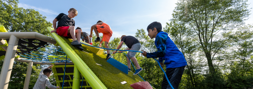 Boys climbing on Playworld's PlayHills